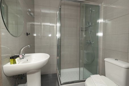 A bathroom with a white sink, a glass shower enclosure, and a toilet.. 2BR Apartment with Balcony in Paralimni