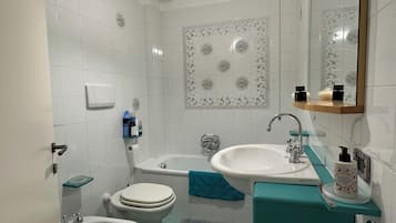 Bidet, towels, soap, toilet paper