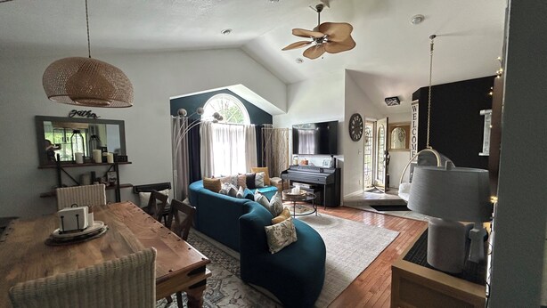 A living room with a sofa, a piano, a television, and a dining area with a table and chairs. - Spacious, 9-bed double house in peaceful setting, 12 miles from Frankenmuth (Clio)