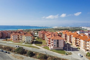 A coastal residential area with apartment buildings, a road, and a beach in the background. - Best Houses 18 - Typical Portuguese Apartament (Consolação)