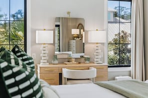 A hotel room with a bed, a desk, two lamps, a mirror, and a view of the outdoors. - Casa Amor|Easy Beach Access|Private Pool|Golf Cart (Seagrove Beach)