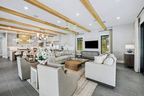 A modern living room with a sofa set, coffee table, and a TV mounted on the wall. - Casa Amor|Easy Beach Access|Private Pool|Golf Cart (Seagrove Beach)