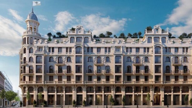 A large, multi-story building with a classical architectural style, featuring balconies and a central tower with a flag. - Spacious 3-Bedroom Apartment in the Heart of Madrid (Madrid)