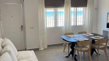 Family Apartment, Sea View | Living area | Flat-screen TV