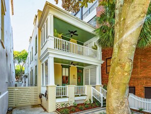 A two-story building with a balcony, a door with a number, and a tree in the foreground. - The Plunge at King Street w/ Private Pool (Charleston)