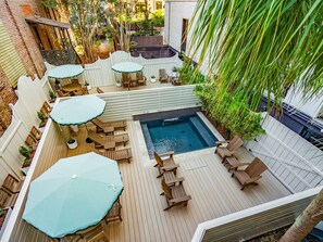 A rooftop patio with a swimming pool, wooden deck, and outdoor seating. - The Plunge at King Street w/ Private Pool (Charleston)