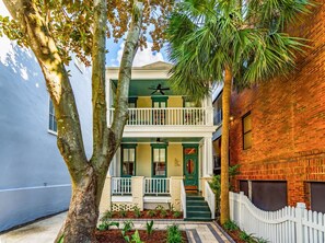 A two-story building with a balcony, a front door, and a small porch area. - Indigo Suite: Heart of Charleston w/ private pool (Charleston)