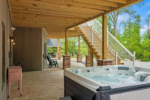 A covered outdoor area with a hot tub, a staircase, and outdoor seating. - The South Harmony House, Luxury Escape, HotTub, 5,000sqft, Gameroom (Lake Harmony)
