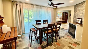A dining area with a table and chairs, a ceiling fan, and a view through a glass door. - Dublin's Private Ranch Retreat (Delaware)