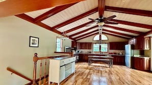 A spacious kitchen with wooden beams, a central island, and a dining area. - Dublin's Private Ranch Retreat (Delaware)