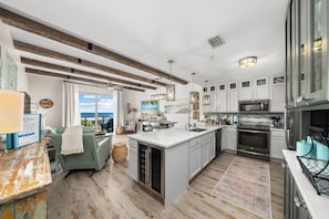 A modern kitchen with a large island, built-in appliances, and a view to the outside. - Beach Resort 501 (Miramar Beach)