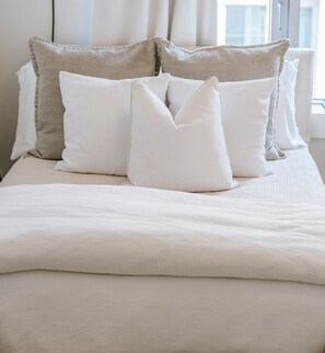 A neatly made bed with a white duvet and several pillows. - “Chambre Pivoine-Demeure Olea” Guest Room in Chérac (Chérac)