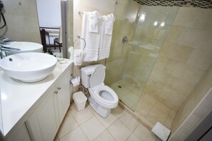 Ein modernes Badezimmer mit einem großen Waschbecken, Toilette und einer Duschkabine.