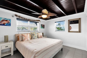 A bedroom with a bed, nightstands, a ceiling fan, and two windows with blinds. - La Pirata: Hgtv-Remodeled 3BR/2BA Canal Home w/ Pool (Marathon)