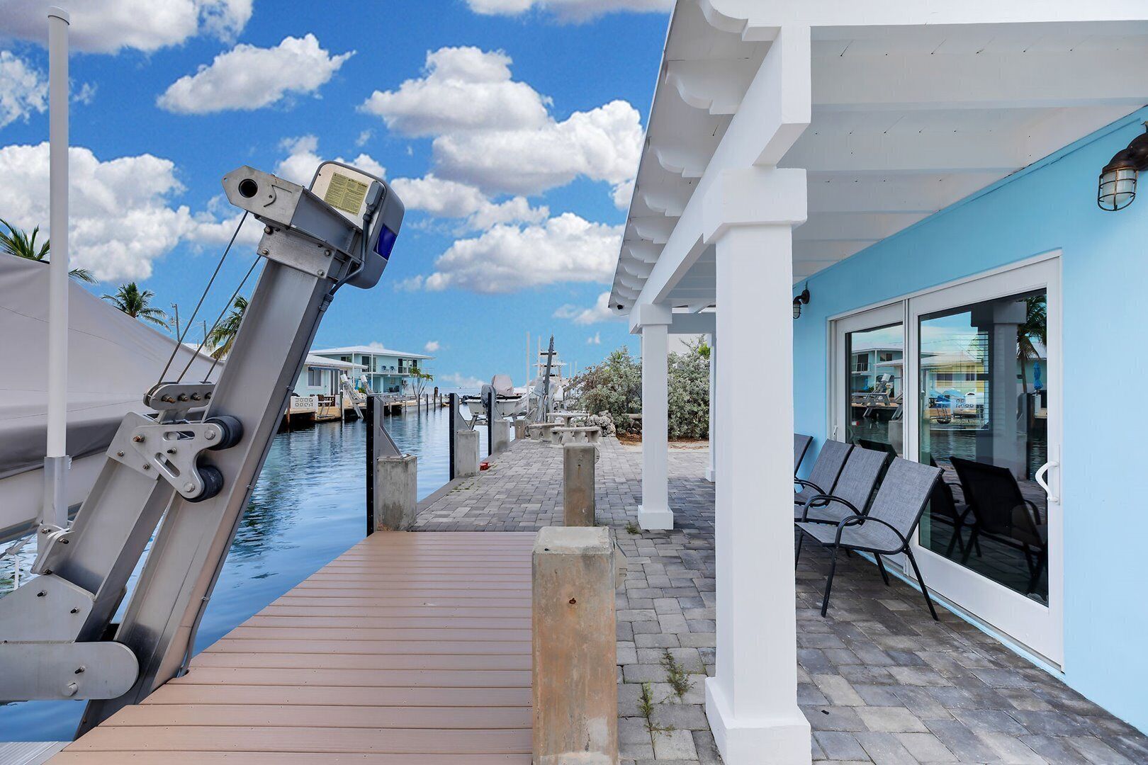 A marina with a wooden dock, a covered seating area, and a view of the water.