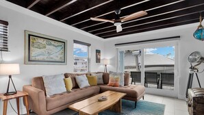 A living room with a sofa, coffee table, and a map on the wall. - La Pirata: Hgtv-Remodeled 3BR/2BA Canal Home w/ Pool (Marathon)