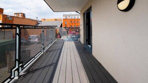 A balcony with a mesh fence, a view of buildings, and a door. - Near LEGOLAND, Heathrow and Historic Windsor (Berkshire)
