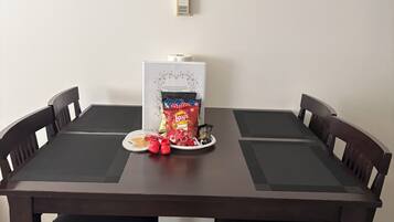Une table à manger avec une horloge au-dessus, entourée de chaises.
