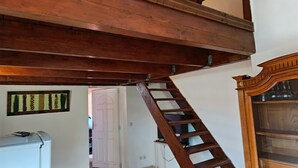 A wooden staircase with a handrail, a white door, and a cabinet with glass doors. - Studio 4 km from the sea swimming pool and garden Bicycle available for hiking (Villeneuve-lès-Maguelone)