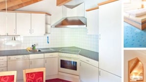 Una cucina moderna con mobili bianchi, una cappa aspirante in acciaio inossidabile e un pavimento rivestito di moquette rossa.