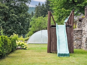 A playground with a slide and climbing structure in a garden setting. - Penzion Exnar by Interhome (Strážné)