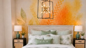 A bedroom with a bed, two nightstands, a wall mural, and a hanging light fixture. - #1 Location I Fully Rebuilt 2026 I .9 Miles to Stadium/2.5 Blocks Downtown (Ann Arbor)