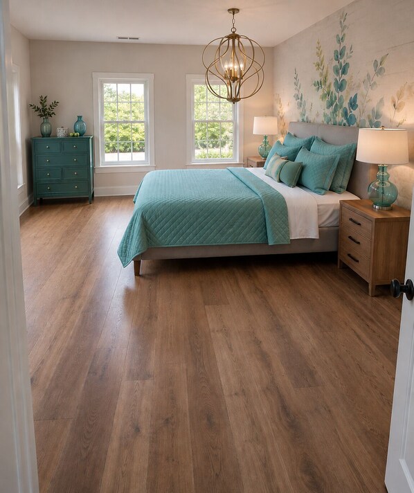 A bedroom with a bed, two windows, a dresser, a nightstand, and a chandelier. - #1 Location I Fully Rebuilt 2026 I .9 Miles to Stadium/2.5 Blocks Downtown (Ann Arbor)