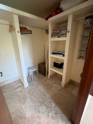 A small room with a closet, a stool, and a shelf with items. - Beautiful apartment in the Zona Romantica, just two blocks from the beach! (Emiliano Zapata neighborhood, Puerto Vallarta)