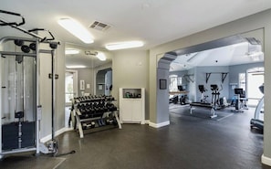 A gym with weightlifting equipment, treadmills, and a mirror. - Scottsdale Retreat: Pool & Sauna (Scottsdale)