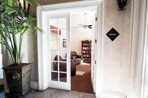 A doorway leading to a living room with a sofa, a bookshelf, and a potted plant. - Scottsdale Retreat: Pool & Sauna (Scottsdale)