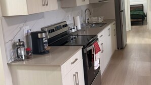 Une cuisine moderne équipée d’une cuisinière, d’un évier et d’un réfrigérateur.