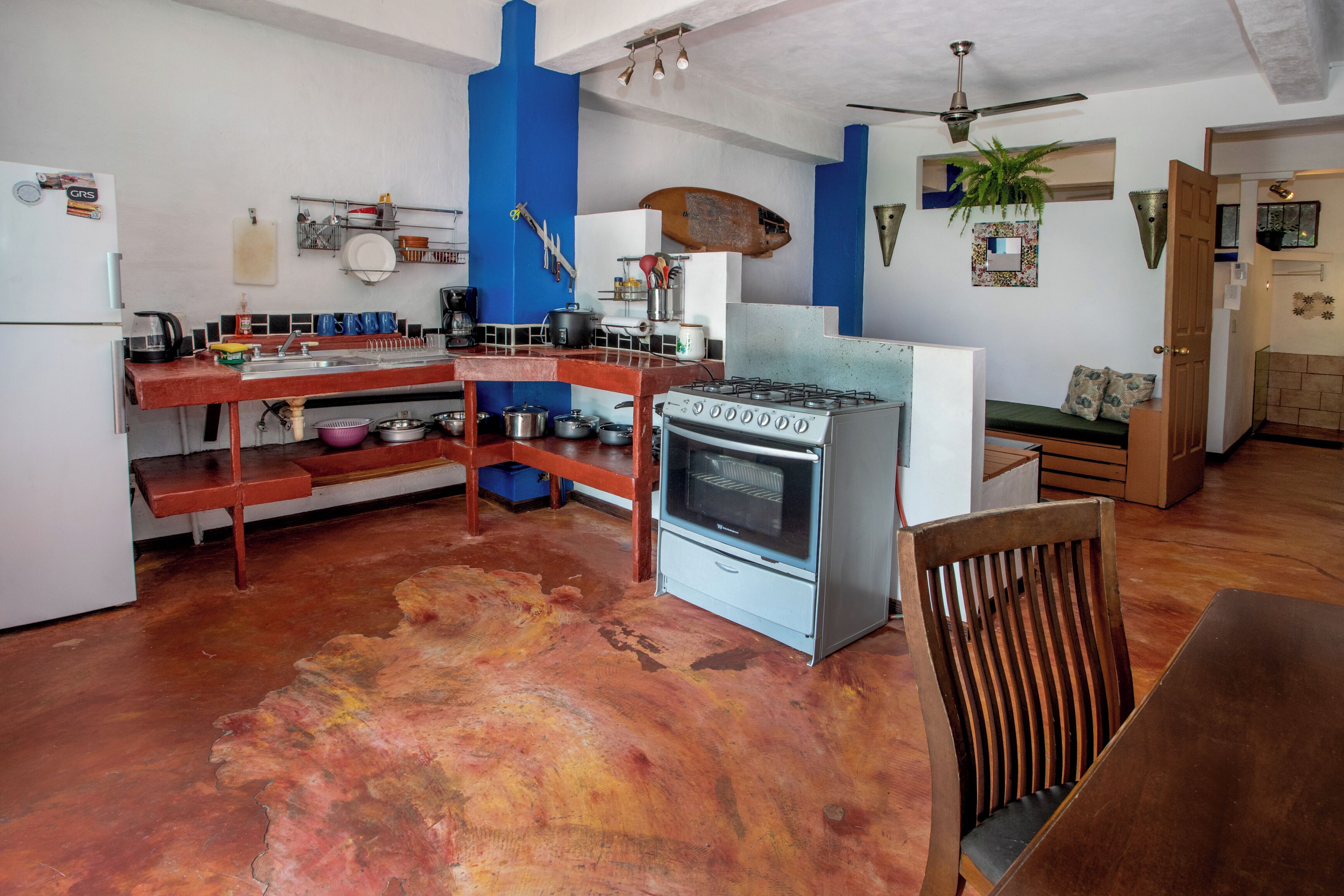 A kitchen with a gas stove, oven, and various utensils.
