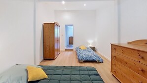 A bedroom with a bed, a dresser, a wardrobe, and a nightstand. - La landaise by Interhome (Saint-Vincent-de-Tyrosse)