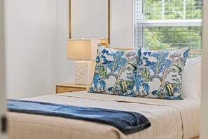 A bedroom with a bed, pillows, a nightstand, a lamp, and a window with blinds. - 3BD/2BA Gem .5 Miles from Cherrydale -  2 King Beds (Greenville)