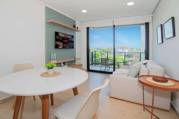 Bright living and dining area with balcony view