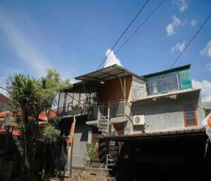 A multi-story building with a staircase, a balcony, and a small window. - Cozzy Pondok Sukamulus (Bandung Barat)