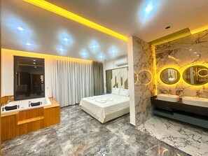 A modern hotel room with a bed, a desk, and a vanity with two sinks. - ELITE Delphin Villas Kalkan, Luxurious, private pool, sea view 4+1 (Kas/Kalkan)