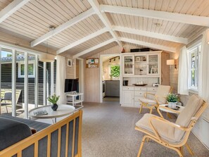 A spacious room with a high ceiling, a dining area, a kitchen, and a seating area with a view. - "Wanna" - 600m from the sea by Interhome (Dannemare)