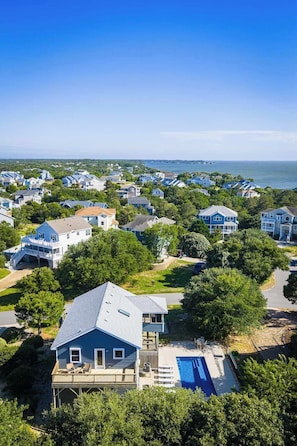 A residential area with houses, a swimming pool, and a view of the ocean. - Close to Beach & Duck Town w Pool & New Updates! (Duck)