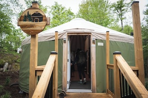 A wooden structure with a sign indicating 'Yourte Laperlierce' and a tent entrance. - Cozy Yurt in the Woods (Sainte-Agathe-des-Monts)