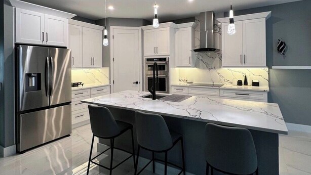 A modern kitchen with a large island, stainless steel appliances, and pendant lighting. - Family Friendly SWFL Home• 3BR, Sleeps 6, Screened Lanai (Fort Myers)
