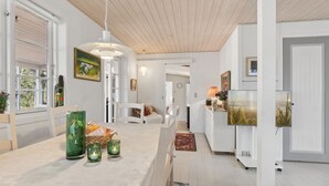 A modern interior with a dining area, kitchen, and living space. - "Mirzə" - 180m from the sea by Interhome (Rønne)