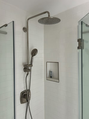 A shower with a handheld showerhead, a wall-mounted rain showerhead, and a handheld showerhead with a flexible hose. - Historic River House with Sunrise Views (New Bern)