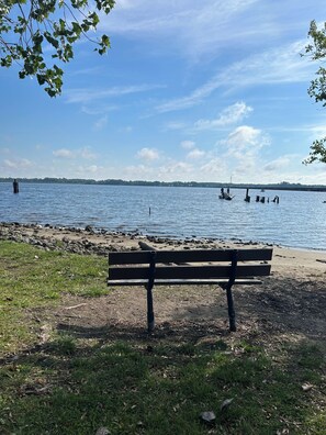 Una banca vora un llac amb barques al capvespre.