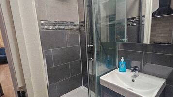 Shower, hair dryer, towels, soap
