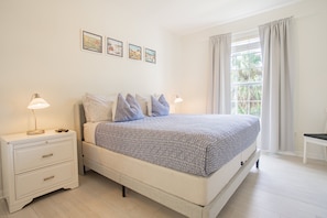 A bedroom with a bed, bedside tables, a window with curtains, and wall art. - Modern 3BR VistaCay Apartment Near Disney, Universal & Orlando Attractions Sleeps 7 (Orlando)