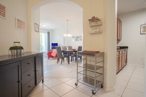 A modern kitchen with a dining area, a chandelier, and a view of the living room. - Modern 3BR VistaCay Apartment Near Disney, Universal & Orlando Attractions Sleeps 7 (Orlando)