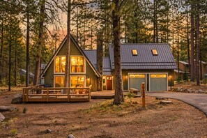 A cabin with a deck, a garage, and a large window. - A-Frame w/ AC | Walk to Glaze Pool | Bunk Room (Sisters)