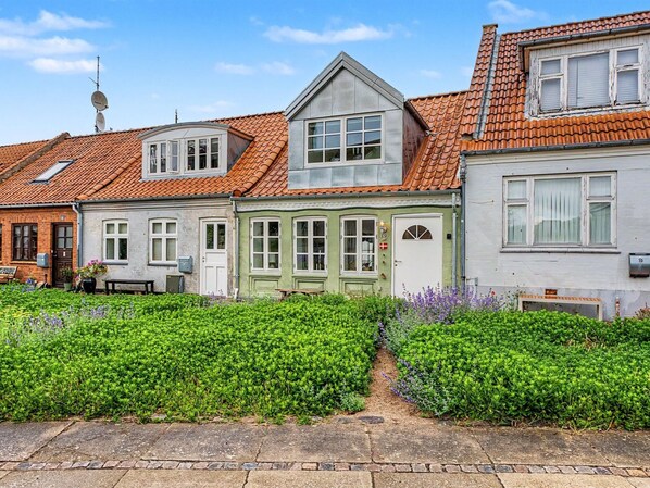 A row of traditional European houses with distinct architectural styles, including a house with a sloped roof and another with a gabled roof. - "Swarthofthi" - 90m from the sea by Interhome (Assens)