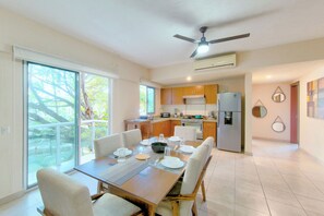 A modern kitchen with wooden cabinets, a built-in oven, and a refrigerator. - Beautiful Condo with pool and close to the beach, centrally located in the North Hotel Zone. (Puerto Vallarta)